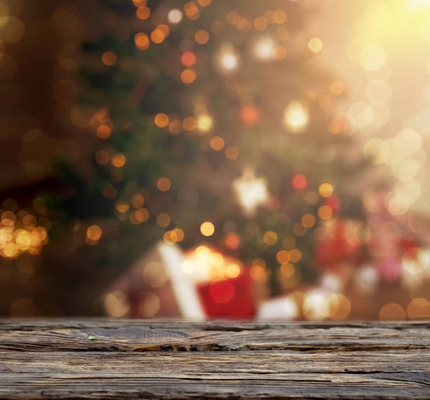 Defocused ornate fir tree with wooden table in front background.