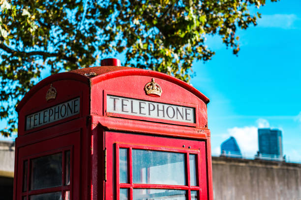Red telephone booth in London with the golden grain