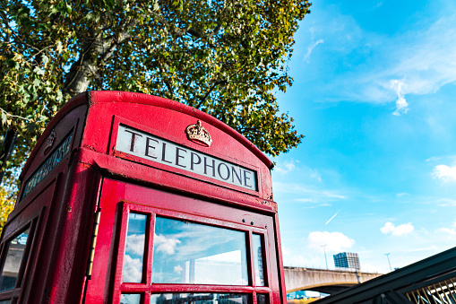 Gibraltar cityscape. Close up of two empty typical English red telephone boxes on pedestrian main street at centre of Gibraltar.