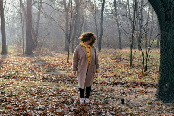 istock Woman in forest holding hand 1353032898