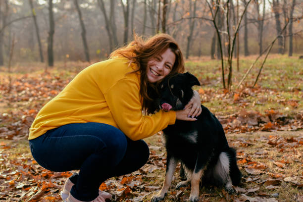istock Woman with black dog 1353035984