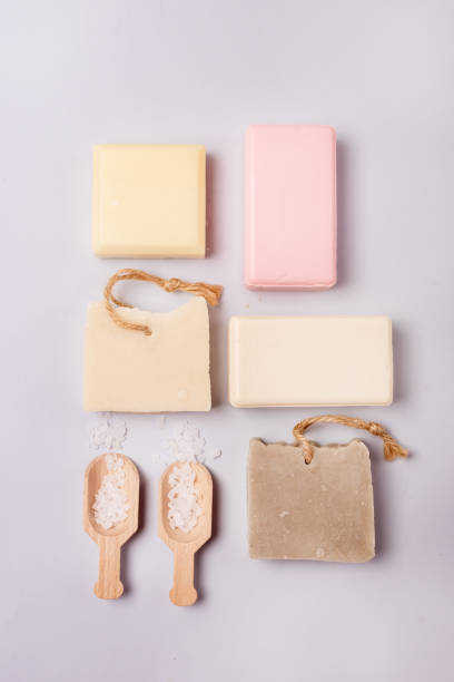 istock Variety of Natural Soaps on Blue Background Handmade Organic Soaps Vertical Flat Lay Scoops with Sea Salt 1353038584