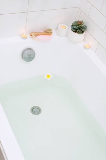 istock Bath Tub SPA at Home Candle Flower Bamboo Face Brush Vertical 1353038703