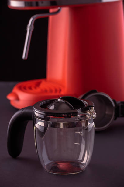 istock A red coffee machine with a glass pitcher against a black background. Still-life with kitchen utensils for making espresso. 1353040388