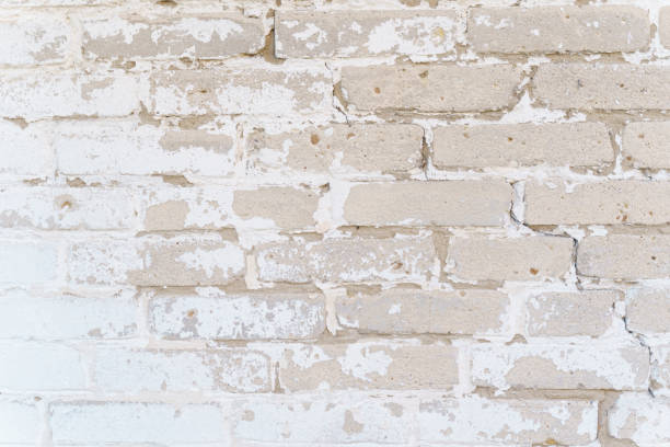 istock Brick wall texture with faded white paint. 1353040429