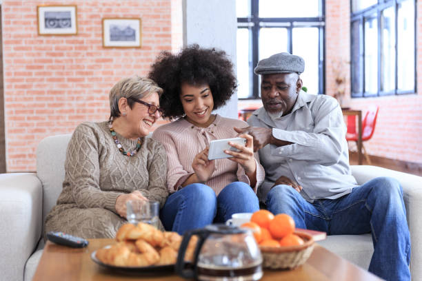 istock Multi-ethnic family having fun at home using smart phone 1353055998
