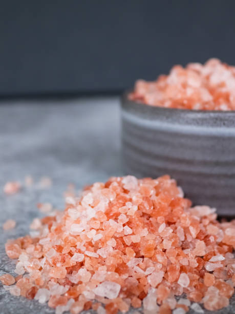 istock Pink Himalayan rock coarse salt in a gray bowl on gray background 1353056133