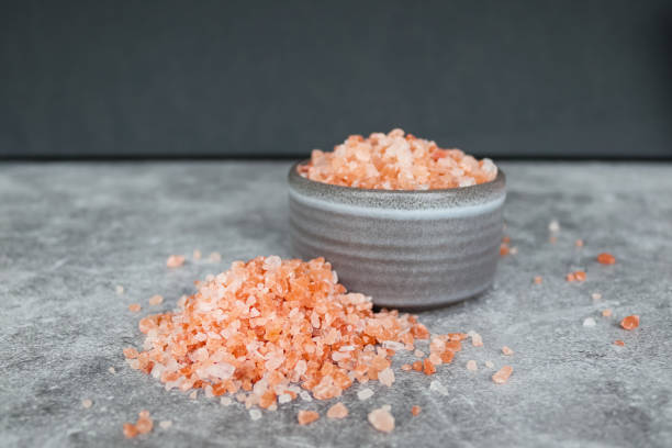 istock Pink Himalayan rock coarse salt in a gray bowl on gray background 1353056135