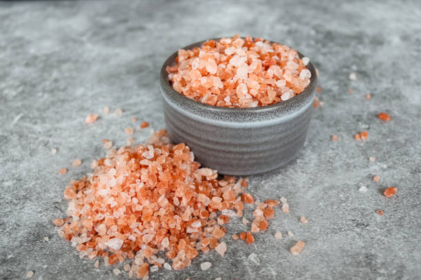 istock Pink Himalayan rock coarse salt in a gray bowl on gray background 1353056148