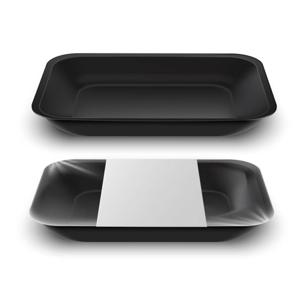 Realistic design template with black food tray on white background. Realistic design template with black food tray on white background. Mock up for packaging design Empty black Plastic Food Container with Label on white  Background polystyrene box stock illustrations