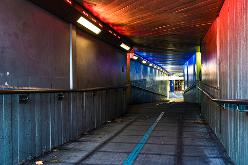 Brixton, London, UK: Subway beneath Brixton railway station at night with colorful art.
