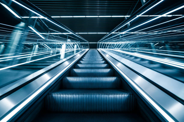 Commuters on escalator at subway station Canary Wharf
