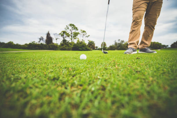 istock Close up, golf ball on the fairway, unrecognizable golfer stands by 1353062806