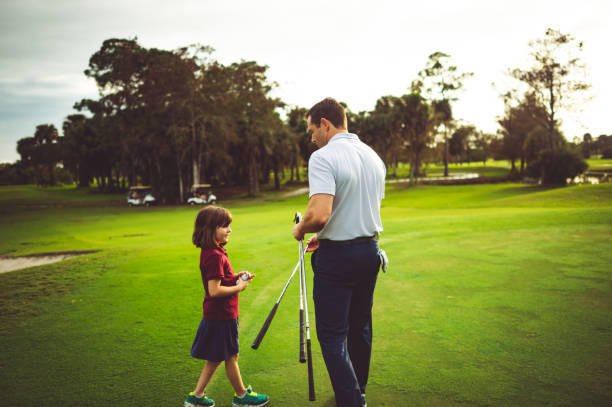 istock Man coaching a girl on a scenic golf course together 1353062826