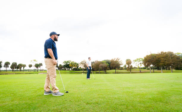 istock Man on a scenic golf course with golf club, golfer enjoying a day on the course 1353062870