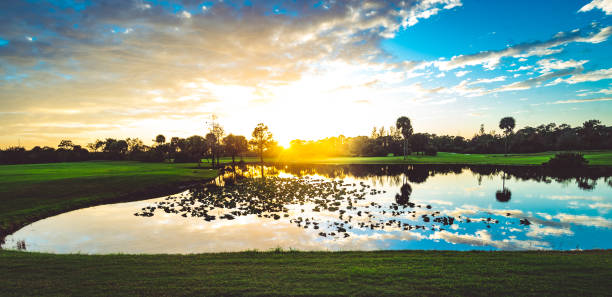 deslumbrante pôr do sol do sul da flórida sobre um lago de campo de golfe, beleza na natureza - golf course fotos - fotografias e filmes do acervo