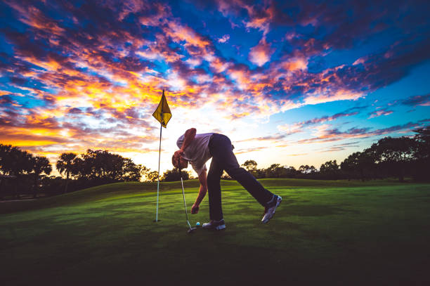 istock Man golfing under stunning sunset sky 1353063951