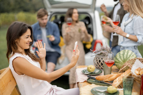 istock Friends tasting wine during picnic near vineyards 1353064164