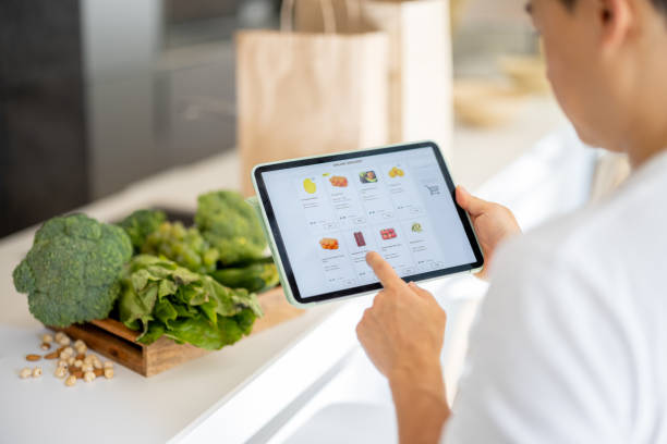 Man watch groceries in online store on gadget stock photo
