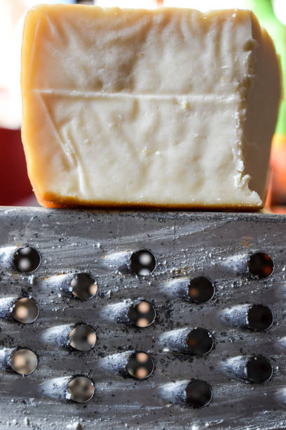 istock Smoked cheese and old cheese grater 1353064803