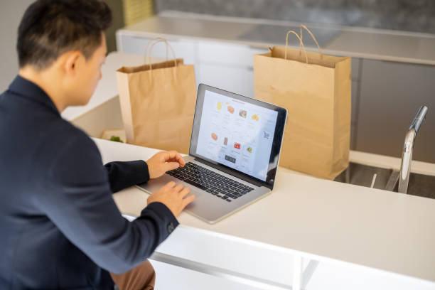 istock Man choosing groceries in online store on laptop 1353064927