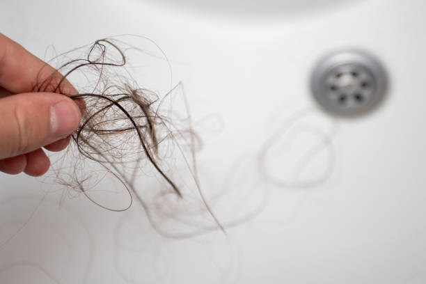 istock Woman holding bunch hair. Hair loss problem 1353066132