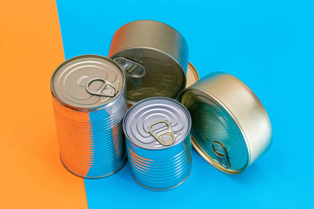 istock A Group of Stacked Tin Cans with Blank Edges on Split Blue and Orange Background 1353066137