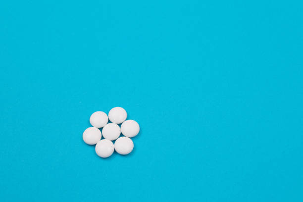 istock Pharmaceutical Industry and Medicinal Products - White Pills on Blue Table 1353066176