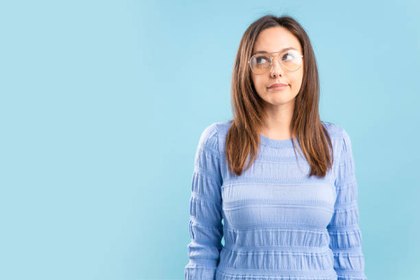 istock Doubtful young woman looking away and making a decision 1353066658