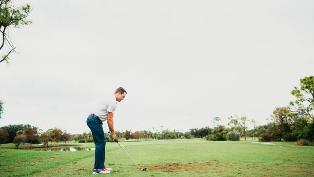 istock Man on a scenic golf course ready to take a swing 1353066684