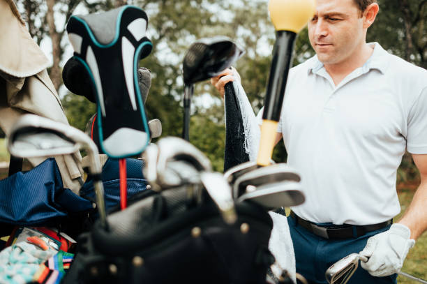istock Man chooses his golf club from a golf bag 1353067451