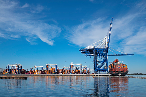 Charleston, SC, USA - November 12, 2021: Gantry cranes, ship-to-shore cranes and container vessel Potomac Express at Hugh K. Leatherman Terminal, which opened in March 2021 on the Cooper River.