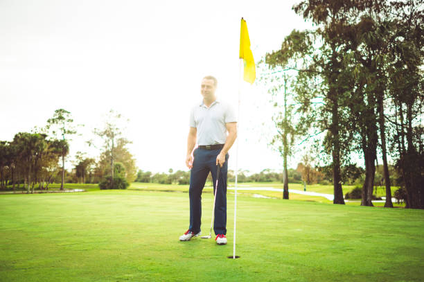 Man looking dejected after missing a putt on golf course