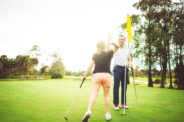 istock High five, father and daughter on the golf course playing a round 1353067874
