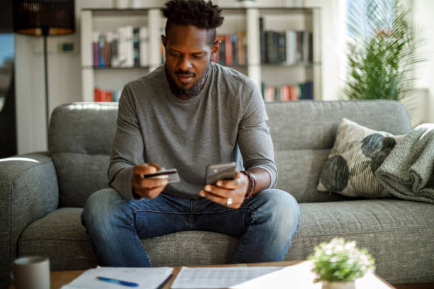 istock Young man shopping online with credit card 1353068012