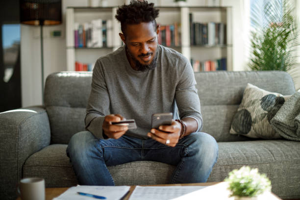 istock Young man shopping online with credit card 1353068020