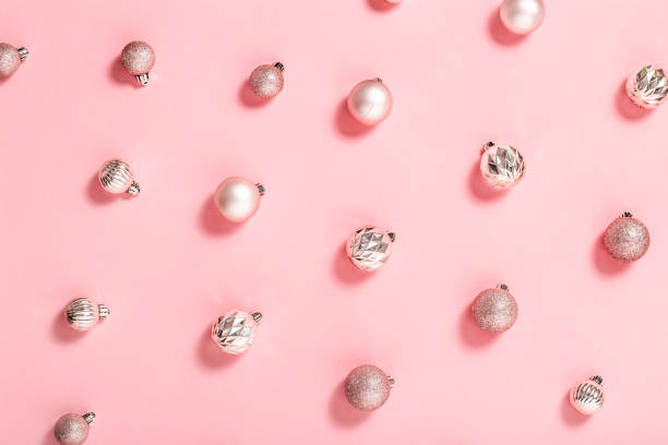 istock Background with beautiful shiny pink decorative balls on a pink background. Top view, flat lay. 1353068863