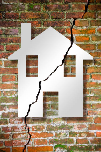 istock Cracked old and aged broken brick wall with a house drawn on it - concept image 1353069103