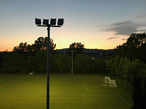 Empty soccer field glows at sunsets