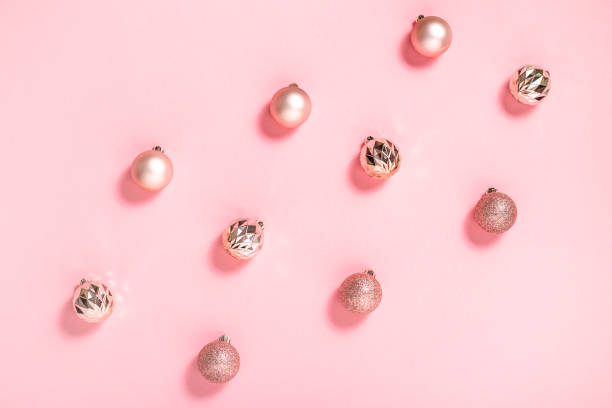 istock Beautiful shiny pink decorative balls on a pink background. Top view, flat lay. 1353069519