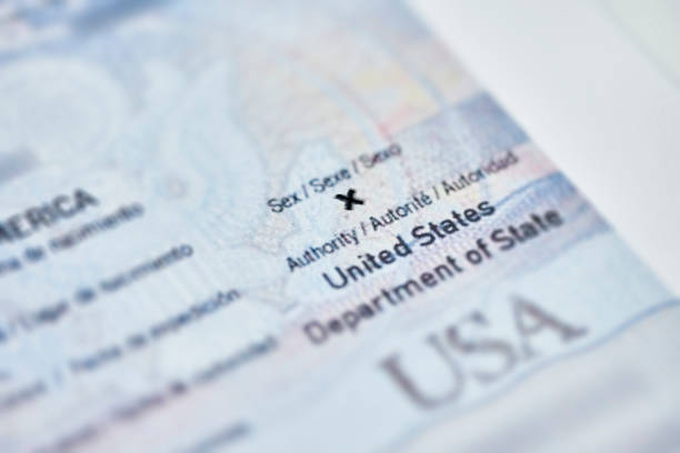 US issues first passport with a nonbinary gender X option US issues first passport with a nonbinary gender X option. U.S. issues its 1st passport with X gender marker. Close-up of passport with first gender-neutral X option gender neutral photos stock pictures, royalty-free photos & images