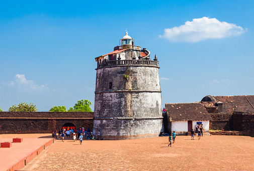 This image showcases the Reis Magos Fort, a historical landmark located along the banks of the Mandovi River in Goa. The fort, known for its distinctive red-laterite walls and rugged architecture, stands as a testament to Goa's rich colonial past. In the photograph, the fort's imposing structure is captured against the backdrop of the lush Goan landscape and the expansive river. The image aims to convey the historical significance of the Reis Magos Fort, highlighting its role as a defensive stronghold and a cultural heritage site. It offers viewers a glimpse into the architectural splendour and strategic importance of this well-preserved fort, making it a captivating subject for those interested in the history and architecture of Goa.