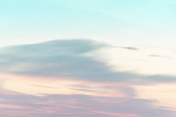 istock sunset background. sky with soft and blur pastel colored clouds.  gradient cloud on the beach resort. nature. sunrise.  peaceful morning. Instagram toned style 1353072553