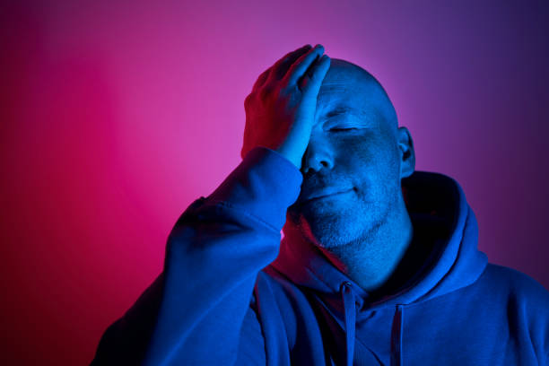 istock Portrait of man in neon lighting 1353072954