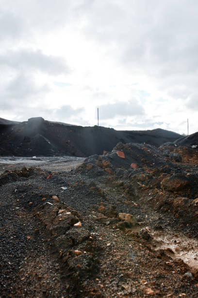 istock Ruined clay road with brick rocks in polluted city with dramatic sky 1353075703