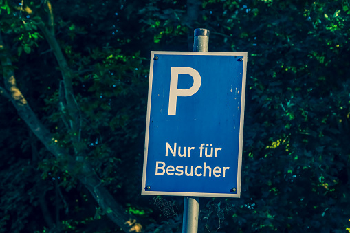 A parking sign with the note \