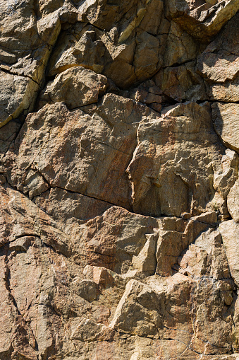 Cracks in the granite rock due to human activity. Destruction of the granite rock of the mountain after the explosion. Concept of environmental problems