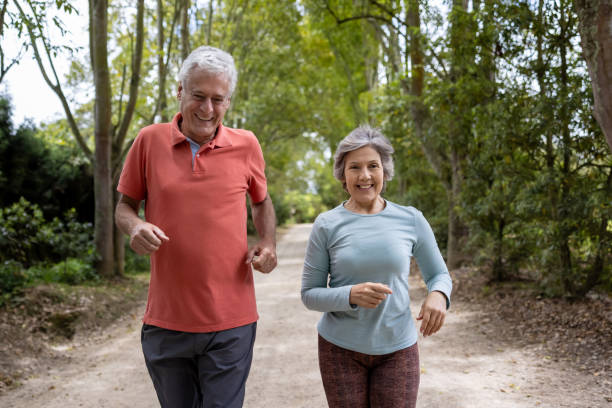 istock Happy senior couple jogging outdoors and smiling 1353083037