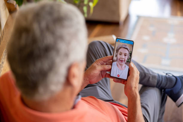 istock Senior man talking to his wife on a video call 1353083065
