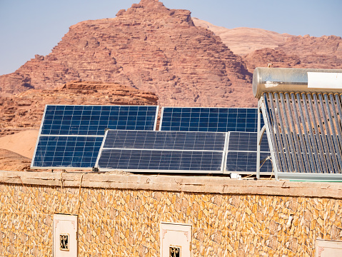 Photovoltaic solar panels on top of a building in Wadi Rum desert, Jordan